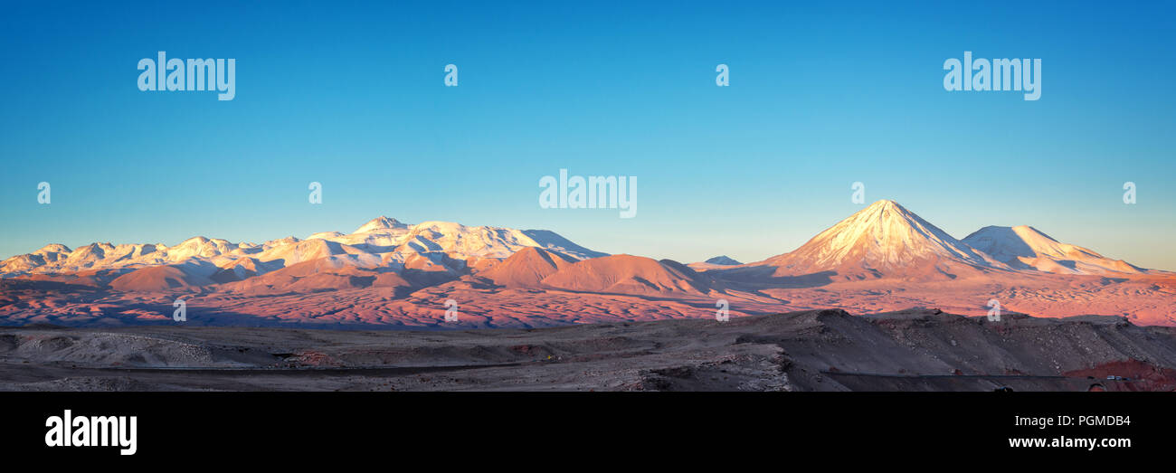 Panorama of Moon Valley in Atacama desert at sunset, snowy Andes mountain range in the background, Chile Stock Photo