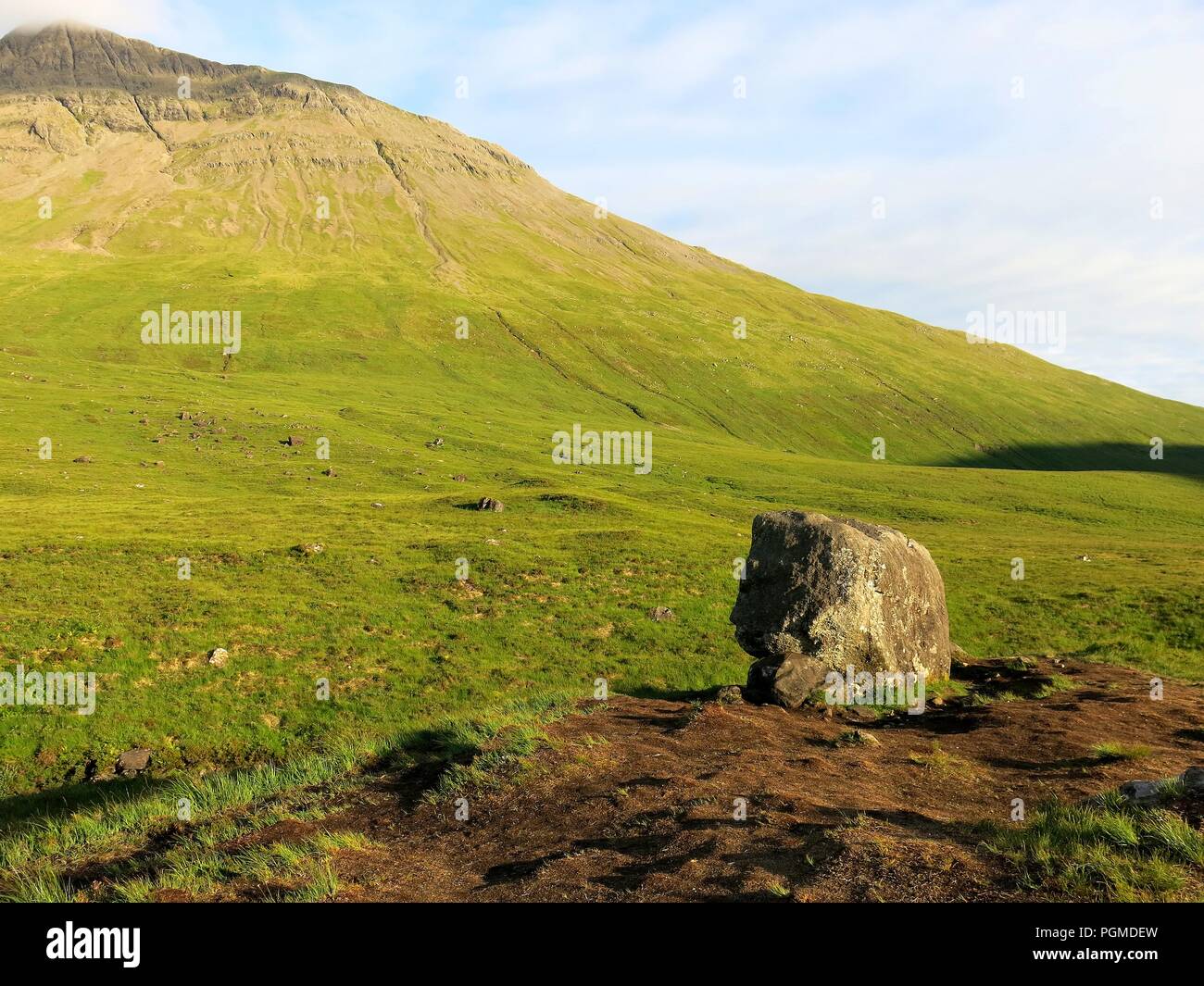 Huge rock lying in the middle of a valley, probably carried by glacier ...