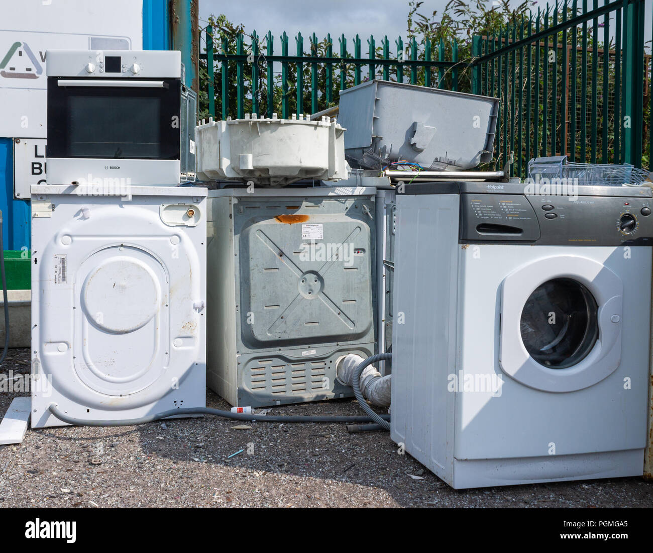 discarded old washing machines being recycled at a municipal dump or council tip. Stock Photo