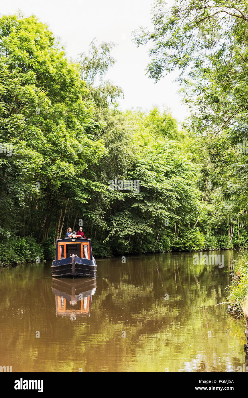 A narrow boat on the Leeds and Liverpool Canal in Yorkshire, UK Stock Photo