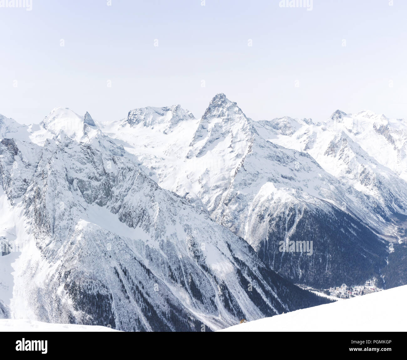 Mountain winter landscape with white peaks. Lifestyle is active, hiking, tourism. Picturesque landscapes of the Alpine mountains in the snow season. Stock Photo