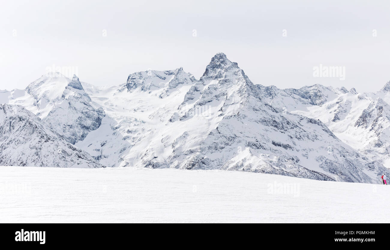 Mountain winter landscape with white peaks. Lifestyle is active, hiking, tourism. Picturesque landscapes of the Alpine mountains in the snow season. Stock Photo