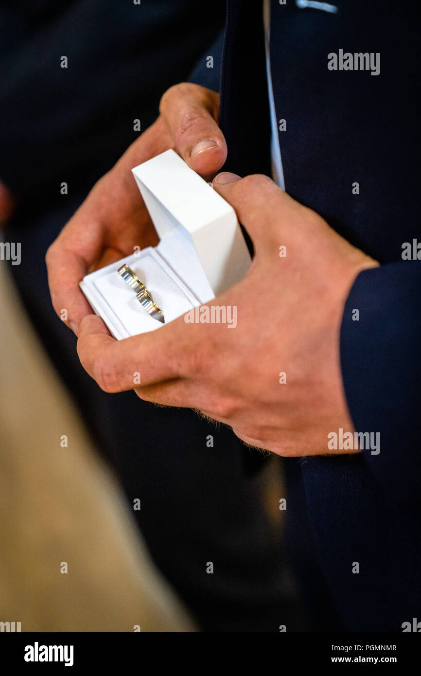 Handsome young man presenting something in a small box, wedding rings, a wedding ring, engagement ring Stock Photo