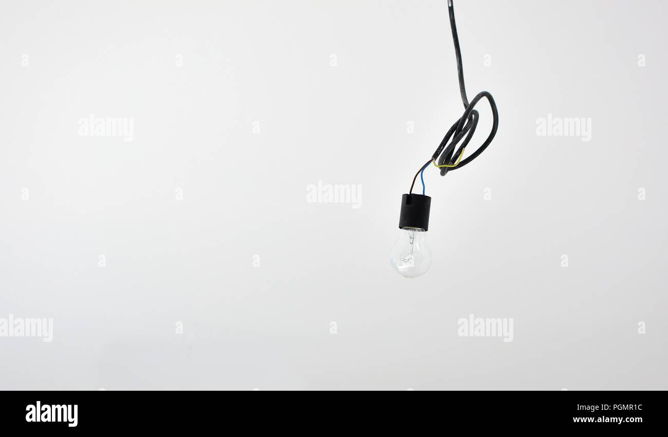 Closeup of light bulb hanging on the electric wires. Stock Photo
