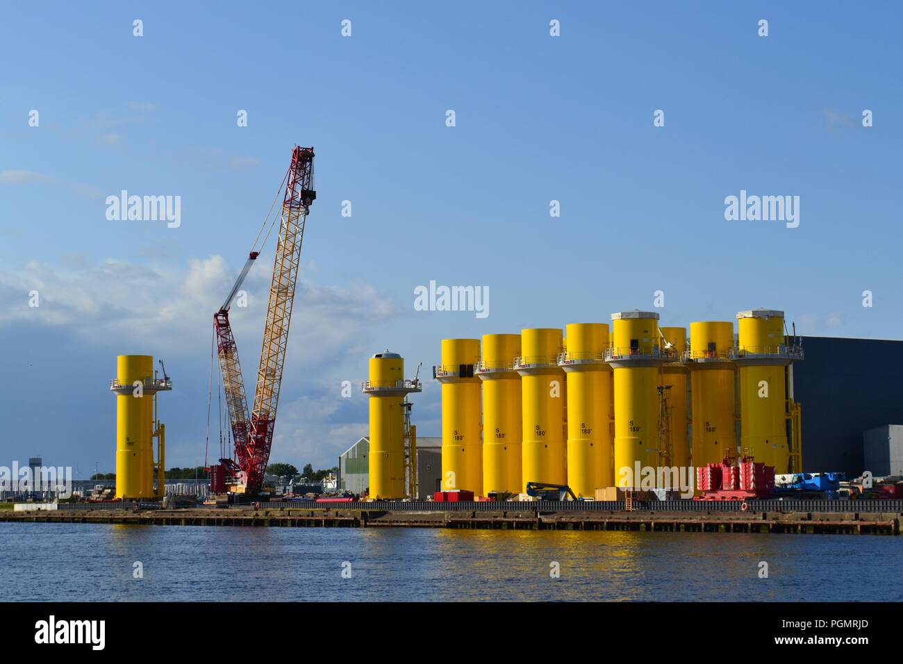 Colourful, naturally lit image of offshore wind farm parts being built/stored at Wilton Group, Middlesbrough, Teesside, UK. Stock Photo