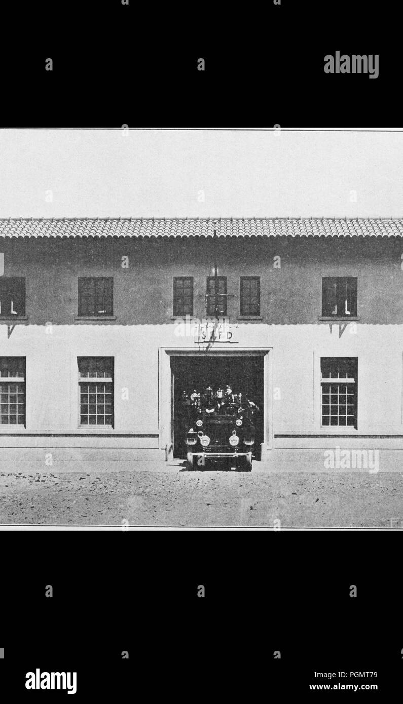 Black and white photograph showing a man standing next to a two-story, fire station, with a barrel tile roof, and a fire engine parked in the open doorway, located between Piers 24 and 26, in San Francisco, California, USA, 1853. Courtesy Internet Archive. () Stock Photo