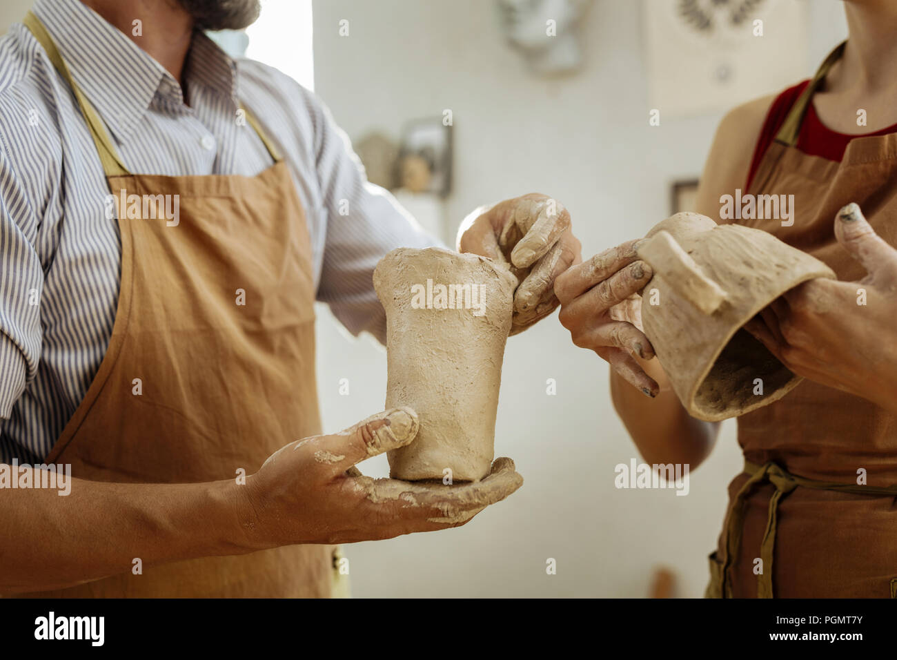 Man and woman attending pottery master class together Stock Photo