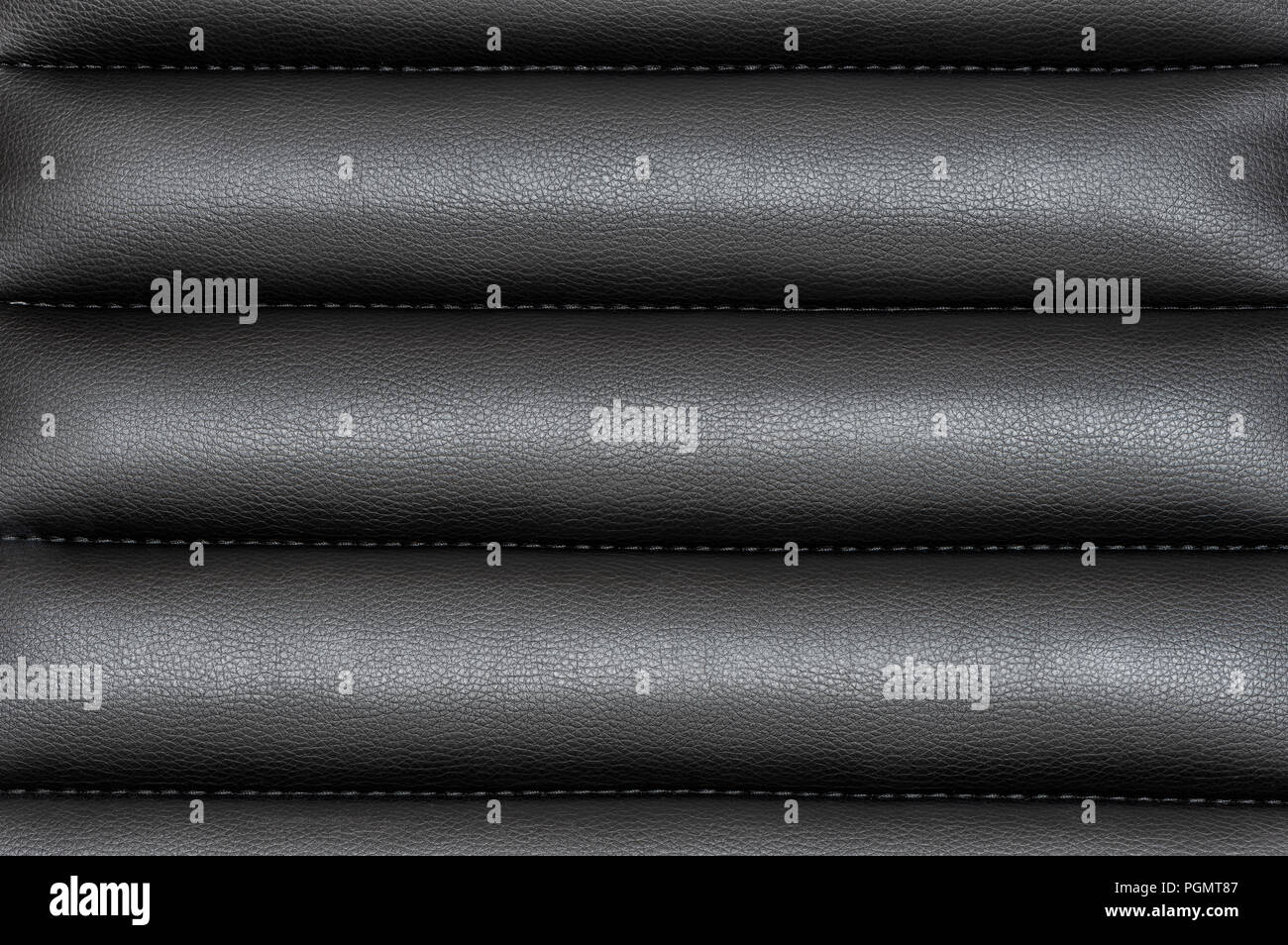 Black wavy leather background with seams Stock Photo