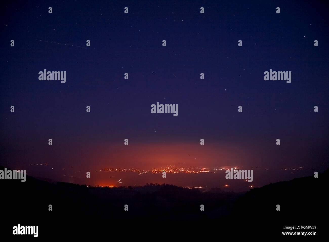 Streetlights of Ruthin at night glowing through fog in the Vale of Clwyd, North Wales Stock Photo