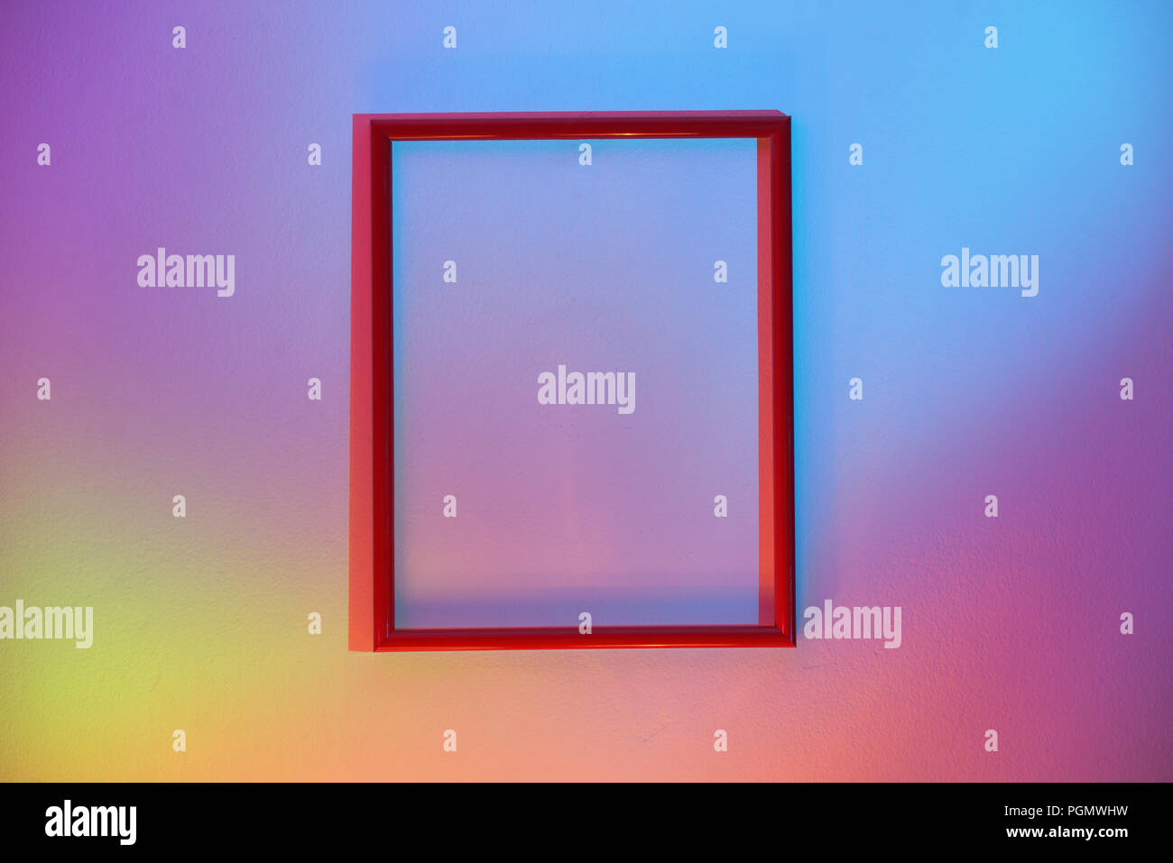 Empty Red Frame Hanging On A Colorful Wall Stock Photo - Alamy