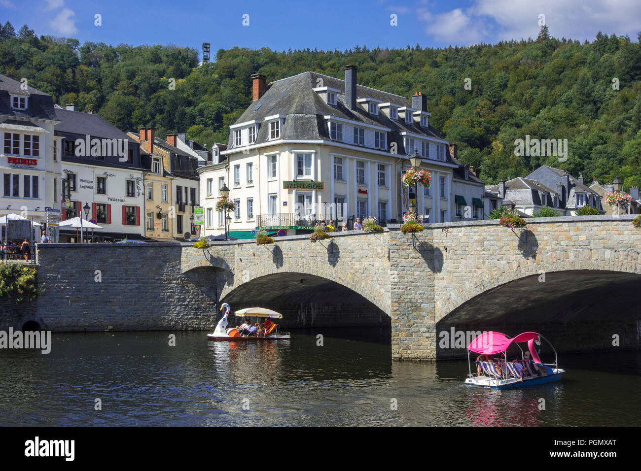 Paddle boats with tourists passing under the bridge Pont de Liège in