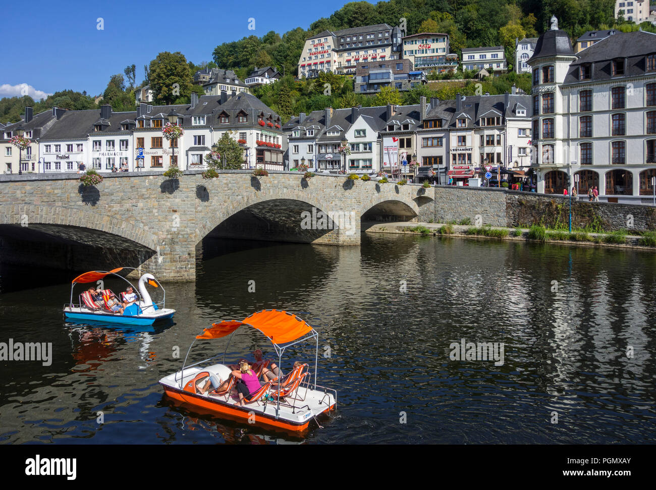 Paddle boats with tourists passing under the bridge Pont de Liège in
