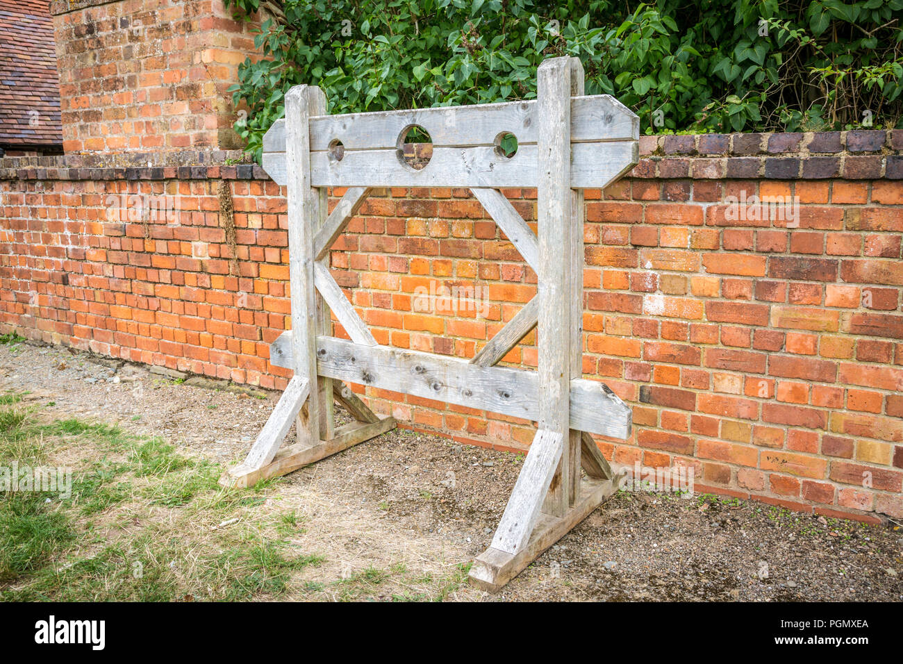 Old wooden stocks, Leigh Court Barn, Worcestershire UK Stock Photo