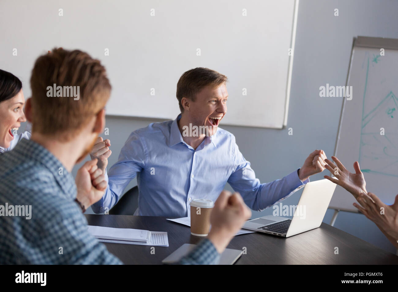 Excited workers scream for shared business goal achievement Stock Photo
