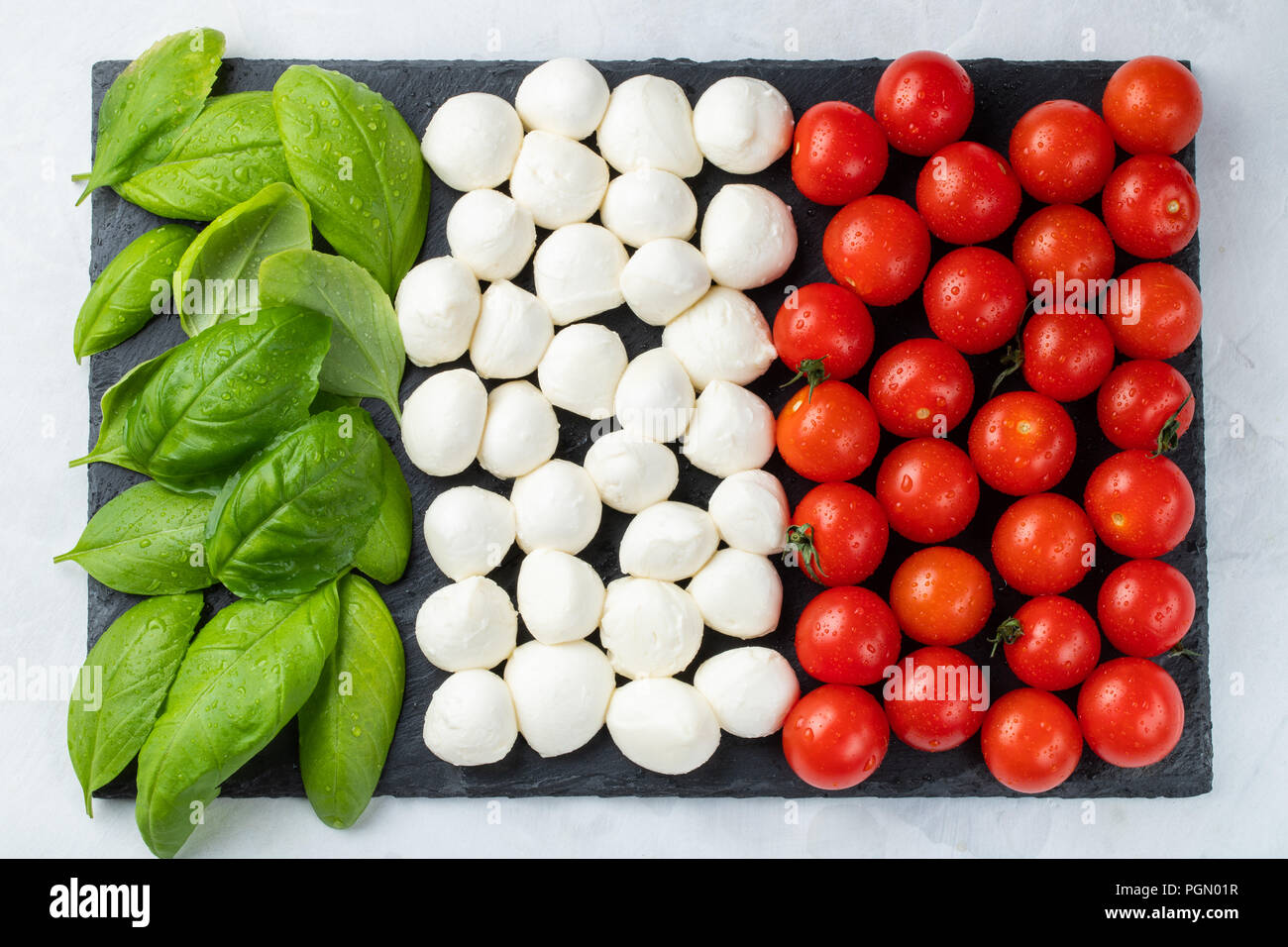 Italian flag made with Tomato Mozzarella and Basil. The concept of