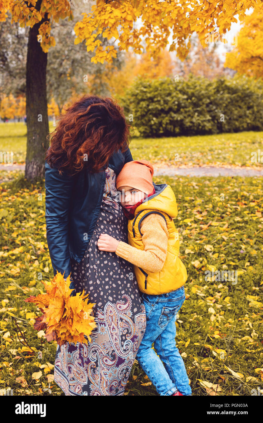 Child boy with his mother in autumn park outdoors Stock Photo - Alamy
