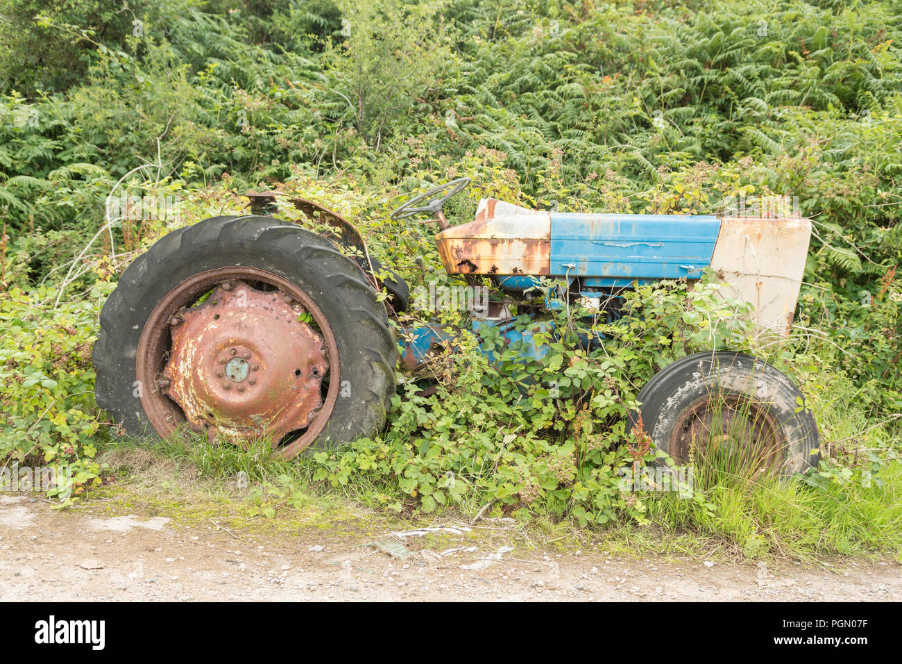 abandoned farm machinery tractor on island - Isle of Gigha, Scotland, UK Stock Photo