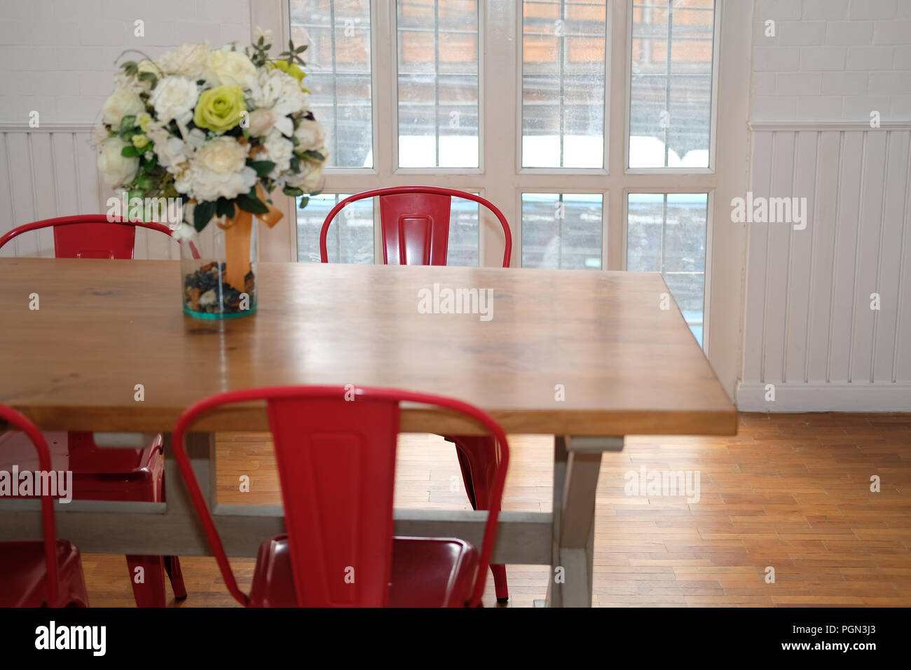 wood table & red chair set in cozy dining room interior Stock Photo Alamy
