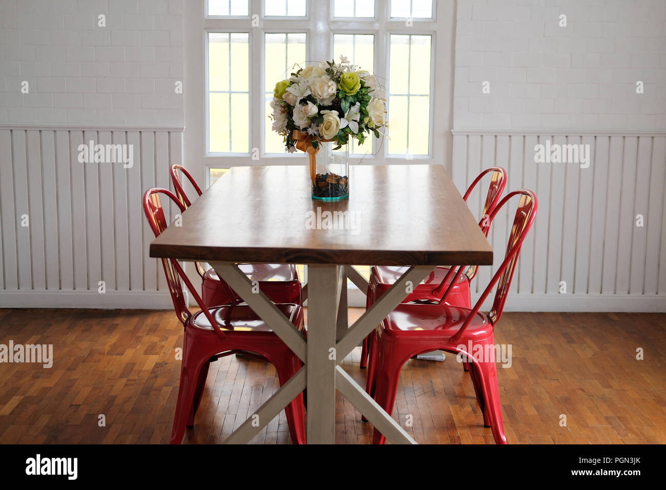 wood table & red chair set in cozy dining room interior Stock Photo Alamy