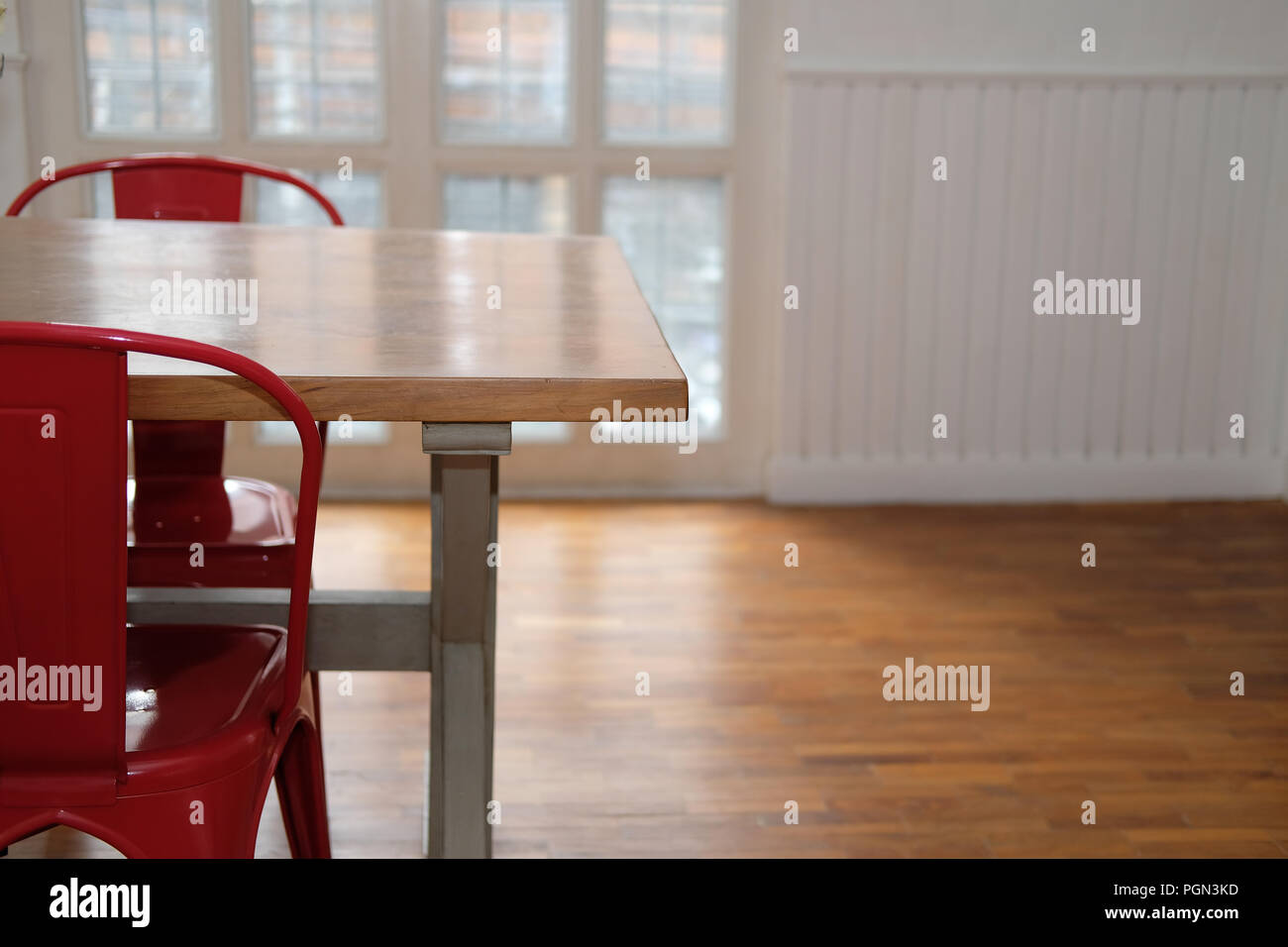 wood table & red chair set in cozy dining room interior Stock Photo Alamy
