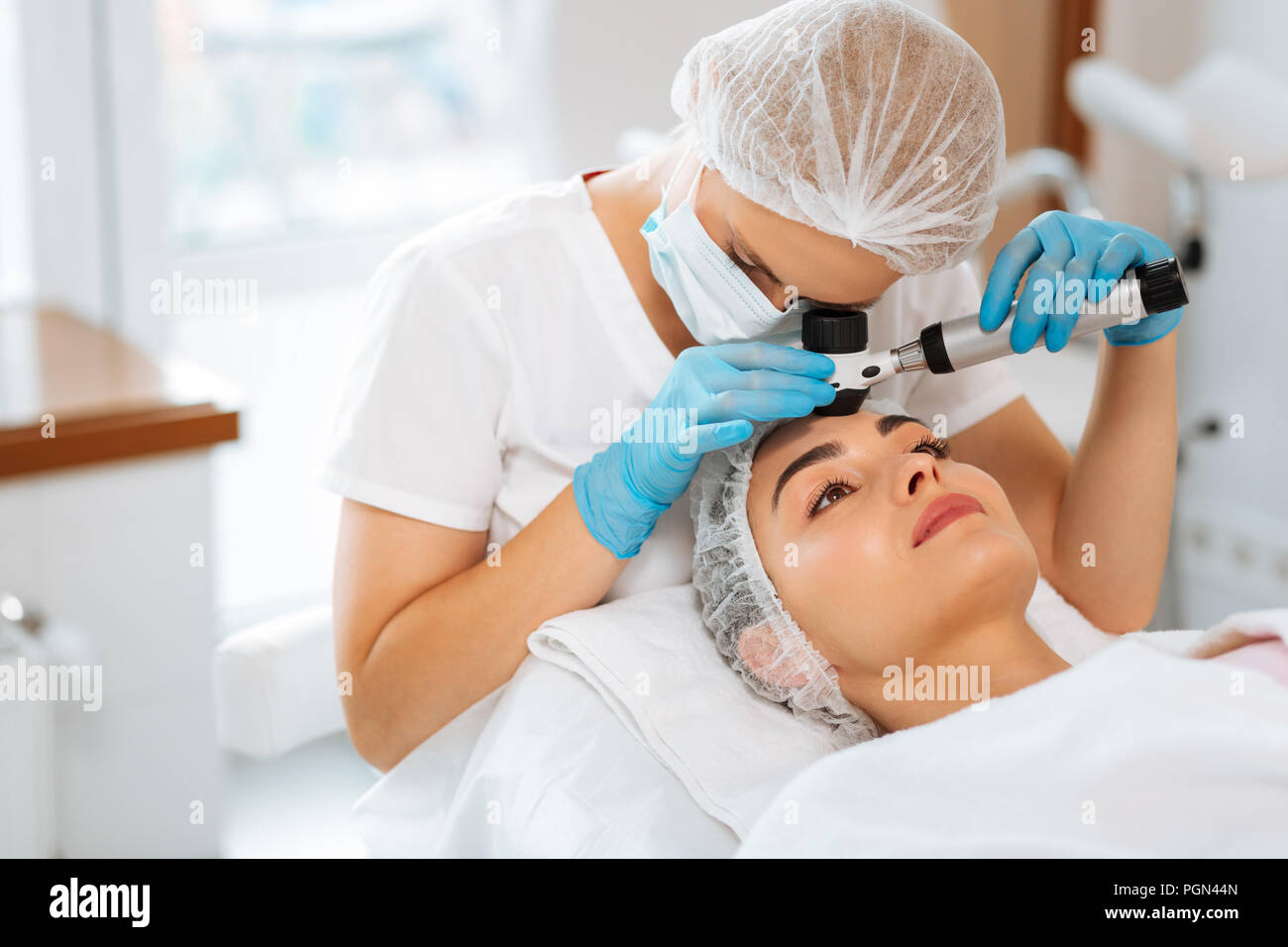 Skilled female dermatologist doing the skin examination Stock Photo Alamy(00)