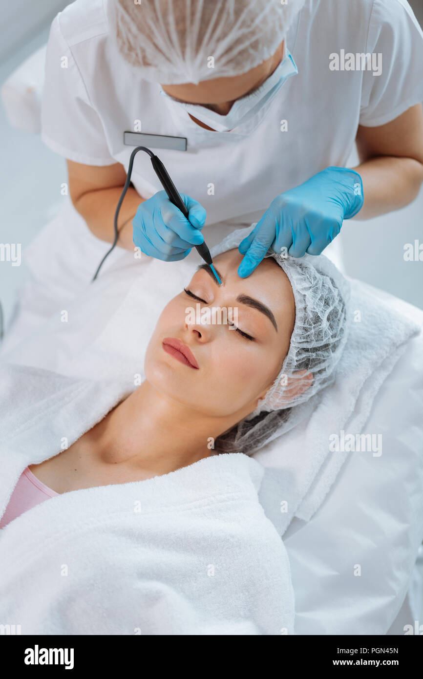 Top view of the process of mole removal Stock Photo - Alamy