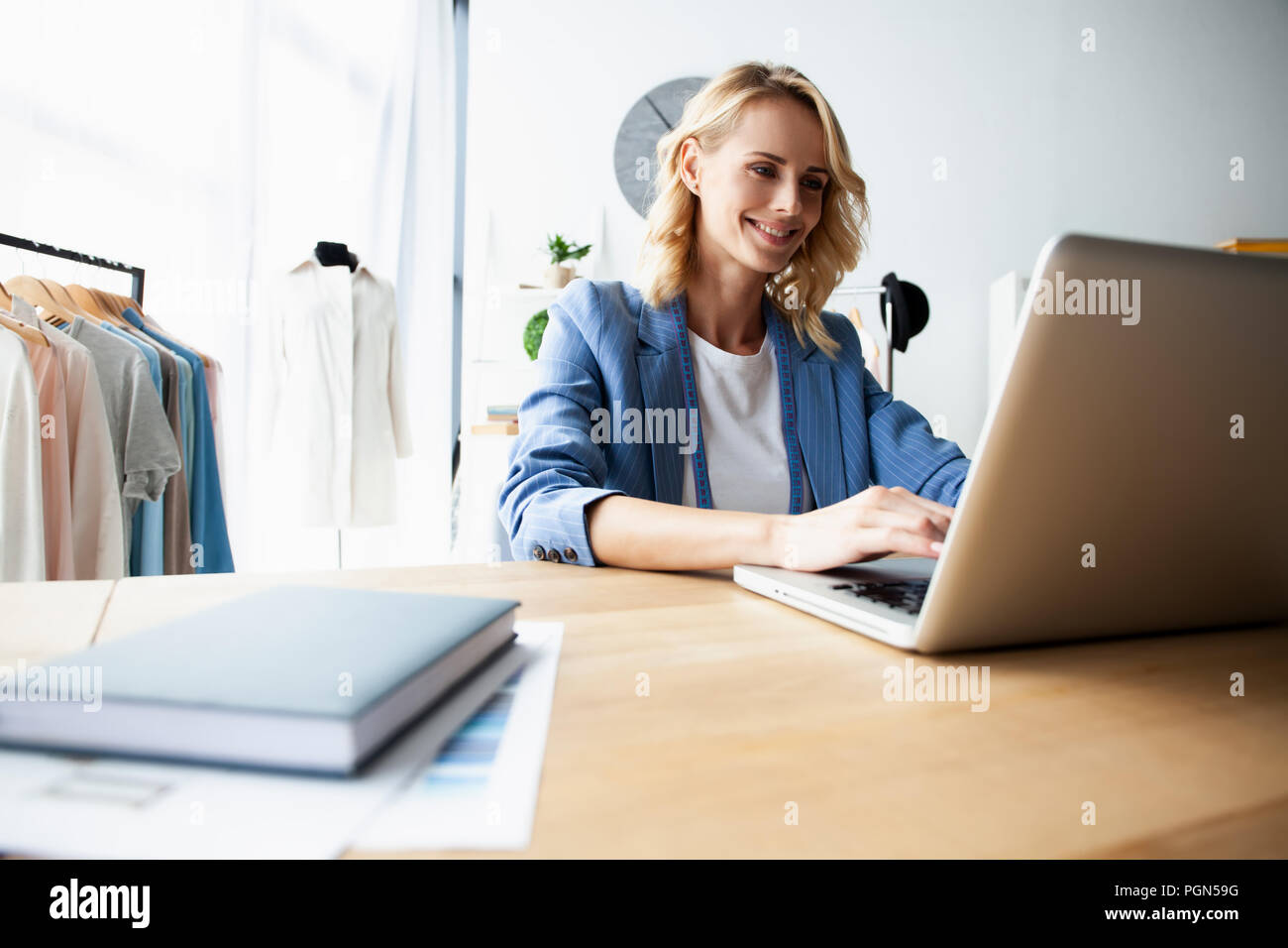 Fashion designer working on her designs in the studio Stock Photo