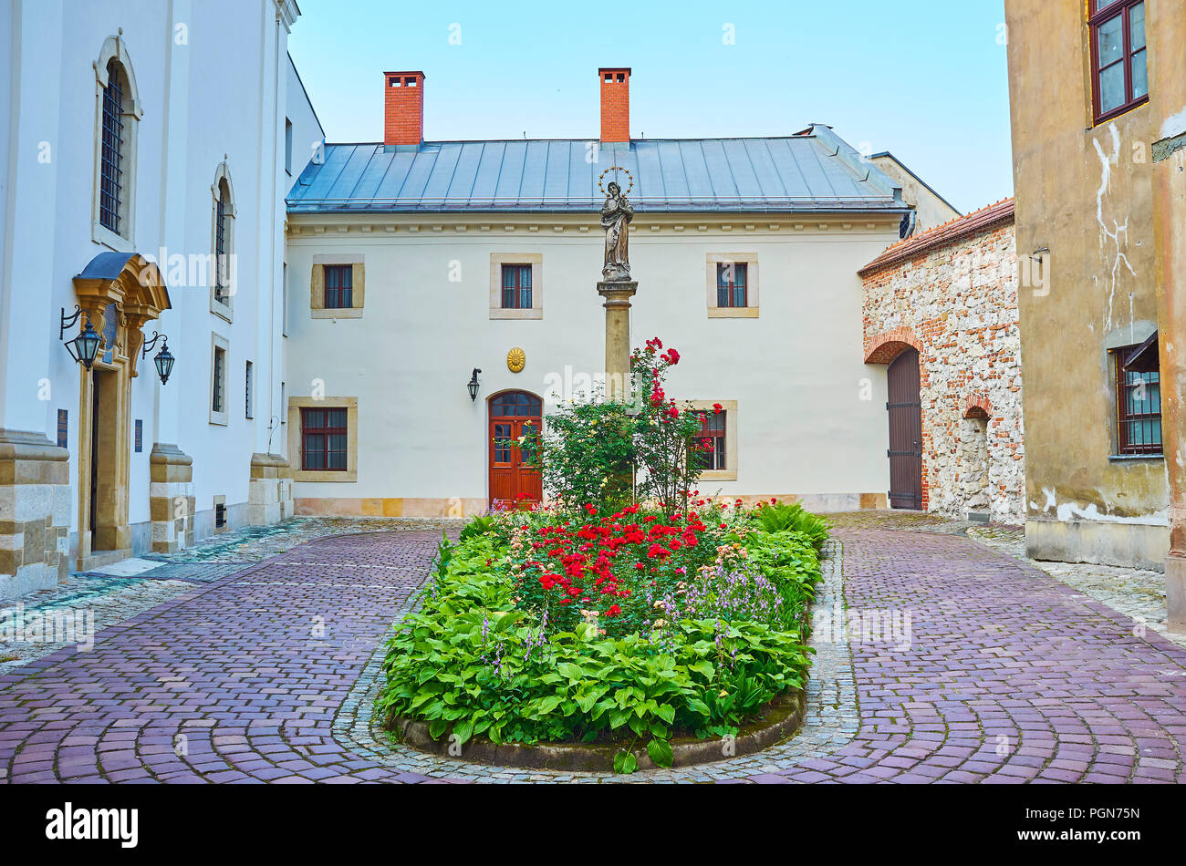 The view on the entrance to the Church on Grodek with beautiful flowerbed in the middle, Krakow, Poland Stock Photo