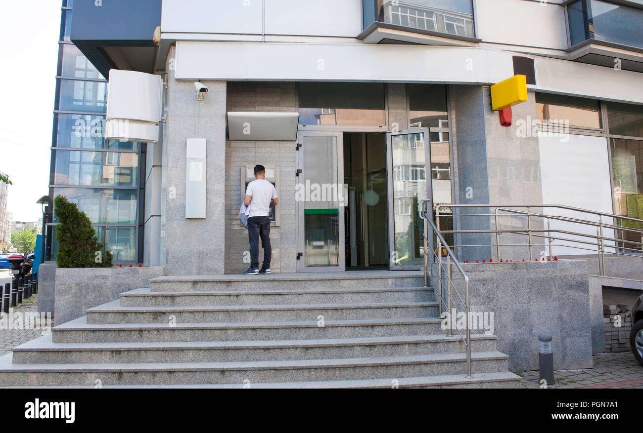 man withdraw money from atm bank in the city Stock Photo