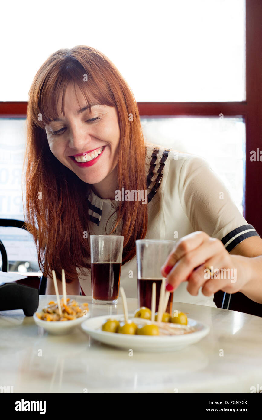 happy woman take spanish vermouth Stock Photo