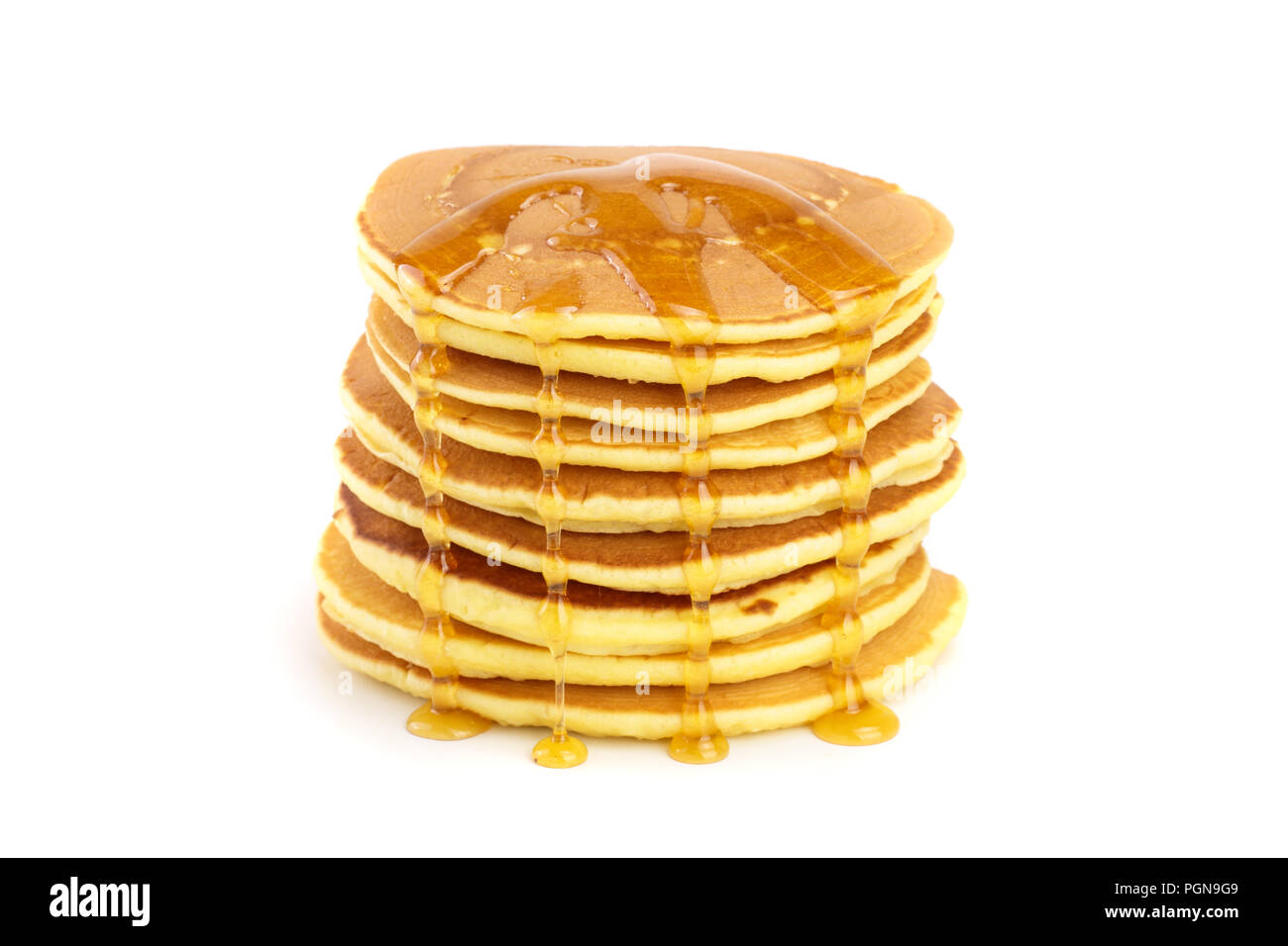 Pancakes stack with honey isolated on white background closeup Stock Photo
