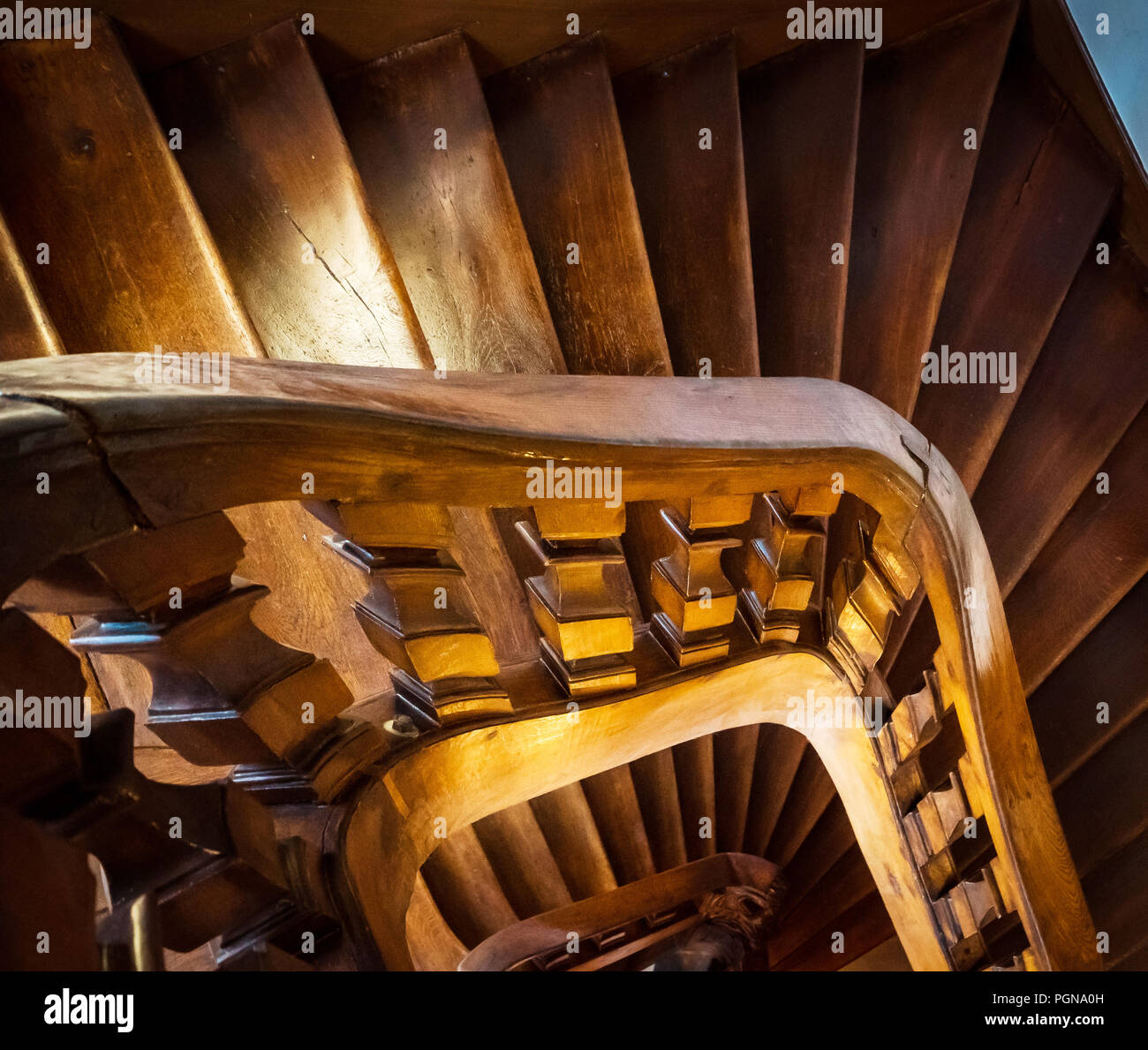 Wooden spiral staircase in old house Stock Photo