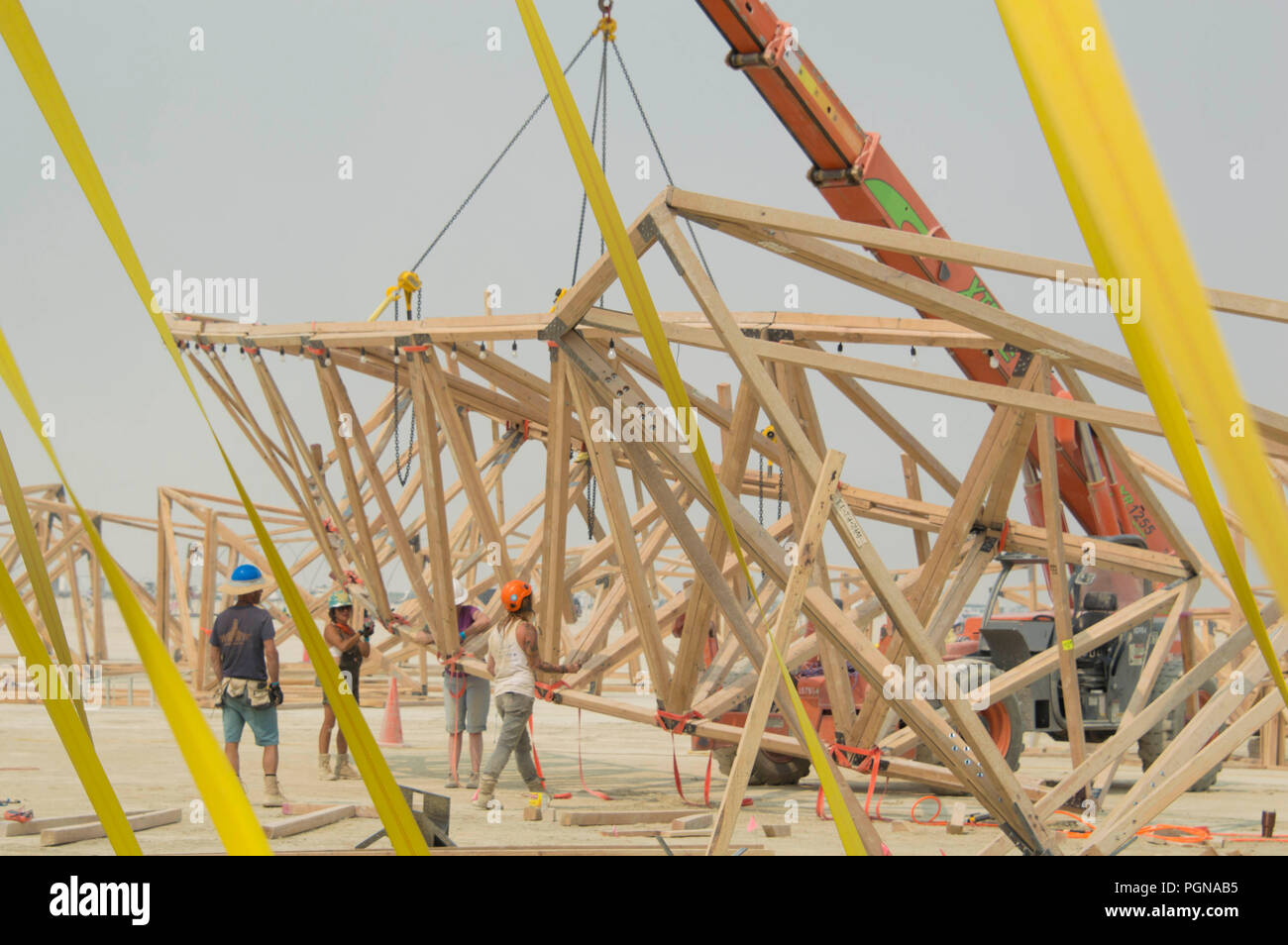 Workers assembly an art installation in preparation at the for attendees at the annual Burning Man counter culture festival in the desert August 23, 2018 near Black Rock, Nevada. Each year 80,000 of people set up a temporary art city in the middle of the desert. Stock Photo