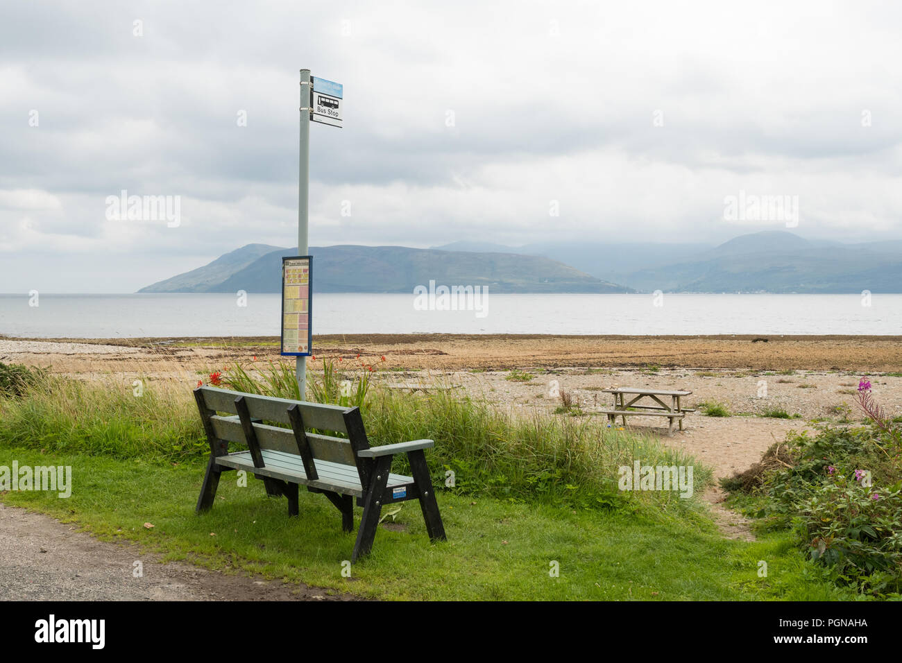 rural bus stop at Skipness, Kintyre, Argyll, Scotland looking out at the beach towards the north west of the Isle of Arran Stock Photo