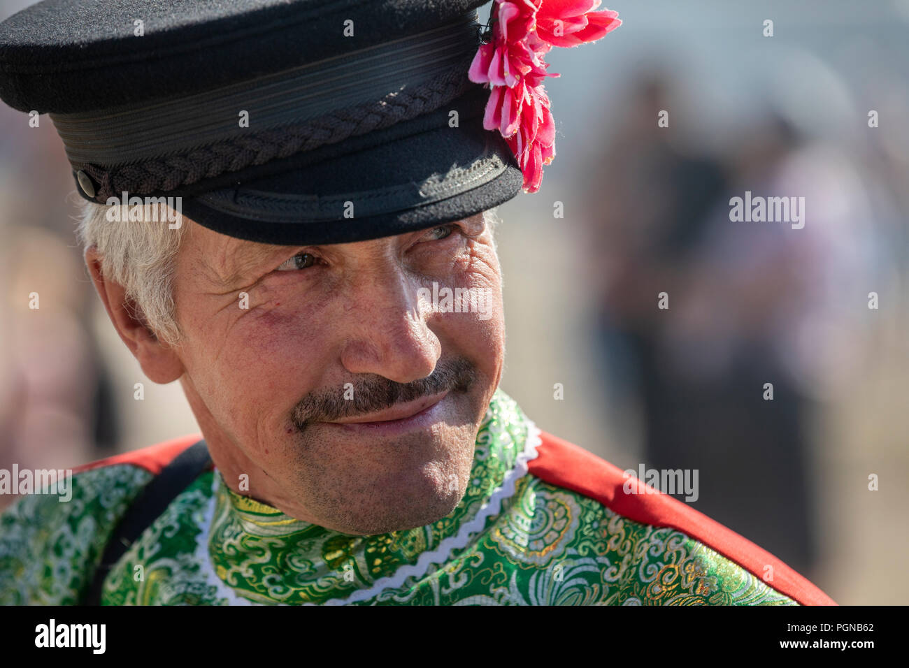 A rural man in a dandy cap with a flower in Atmanov Ugol village of the Tambov region during a rural holiday, Russia Stock Photo