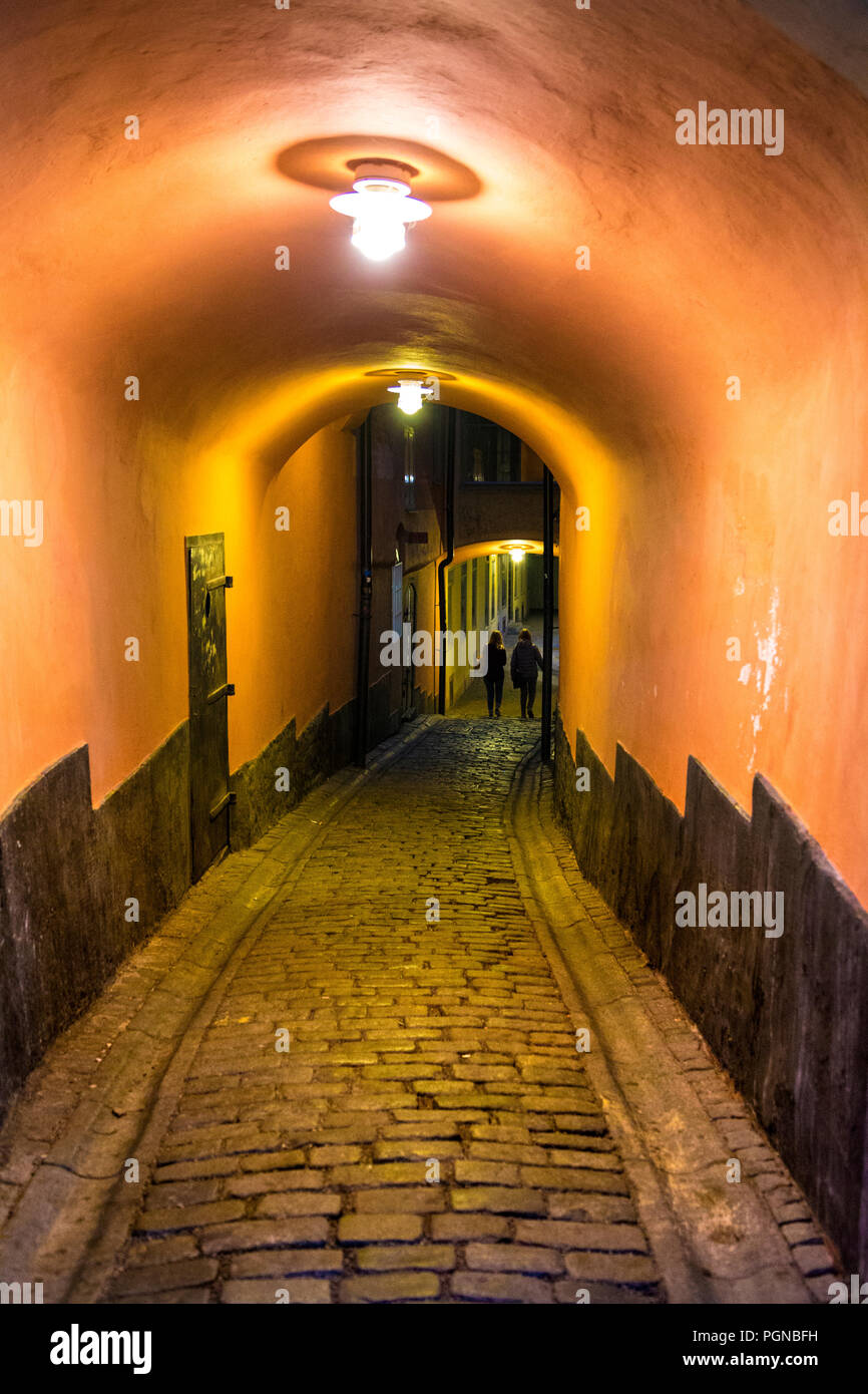 Dark narrow tunnel alley in Gamla Stan (Old Town, Stenbastugränd, Stockholm, Sweden Stock Photo