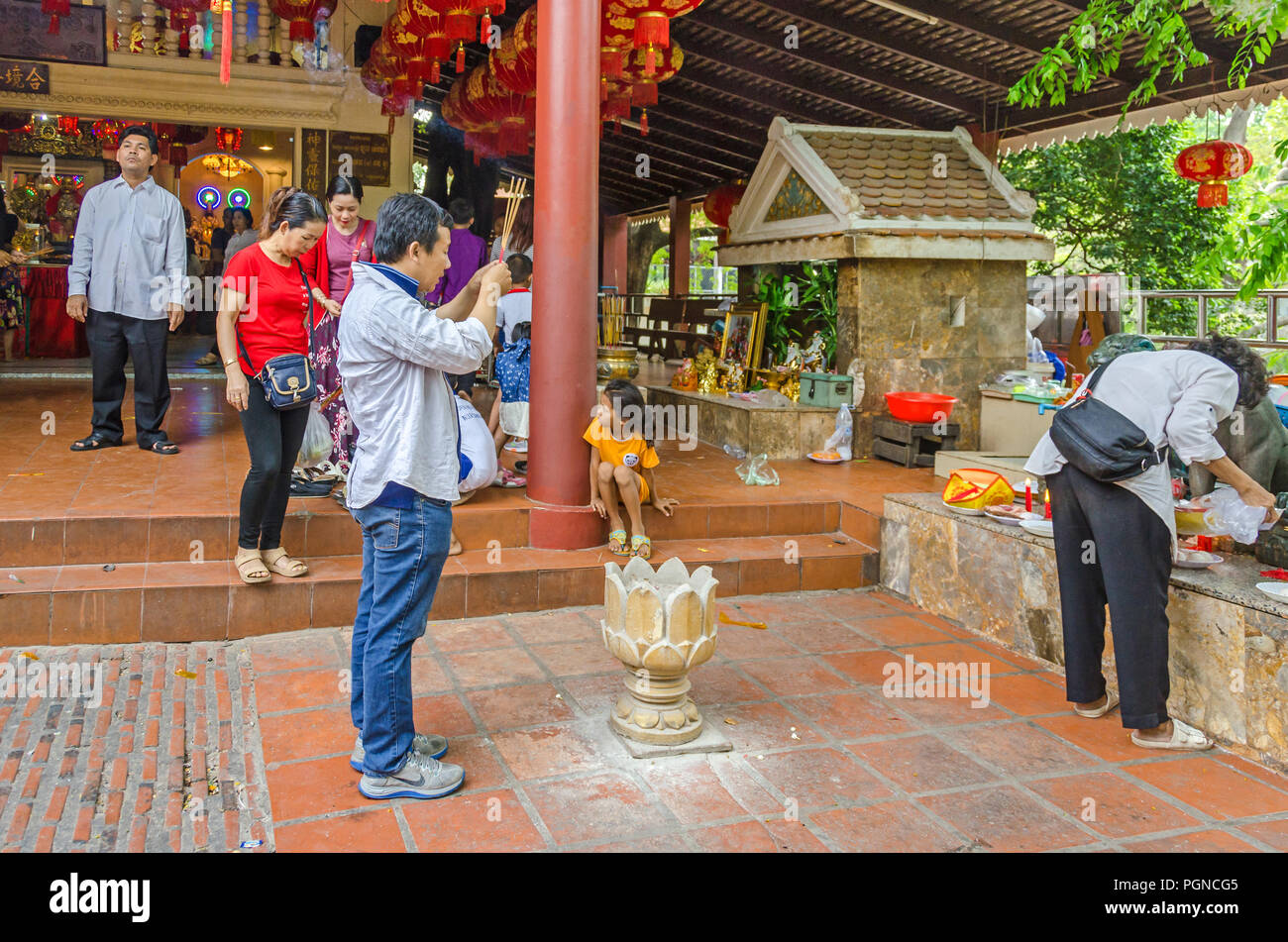 Phnom Penh, Cambodia - April 8, 2018: Devout  buddhists practicing their rituals in the Pagoda of Wat Phnom (Mountain Pagoda), the central point of Ph Stock Photo