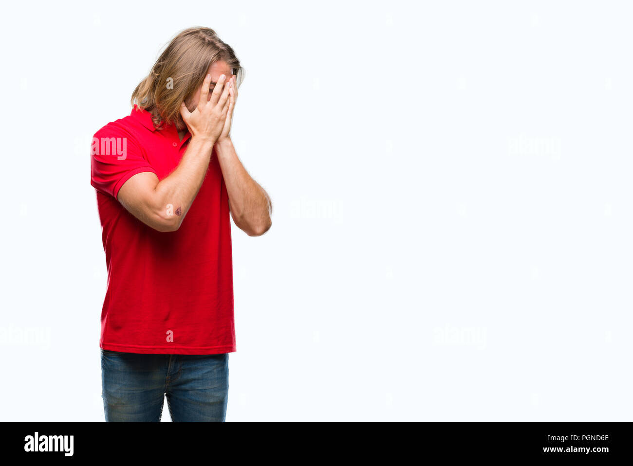 Young handsome man with long hair over isolated background with sad expression covering face with hands while crying. Depression concept. Stock Photo