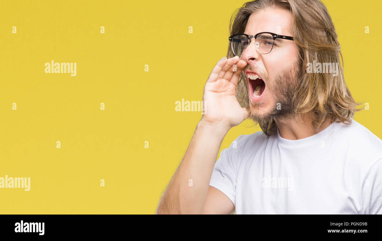 Young handsome man with long hair wearing glasses over isolated ...
