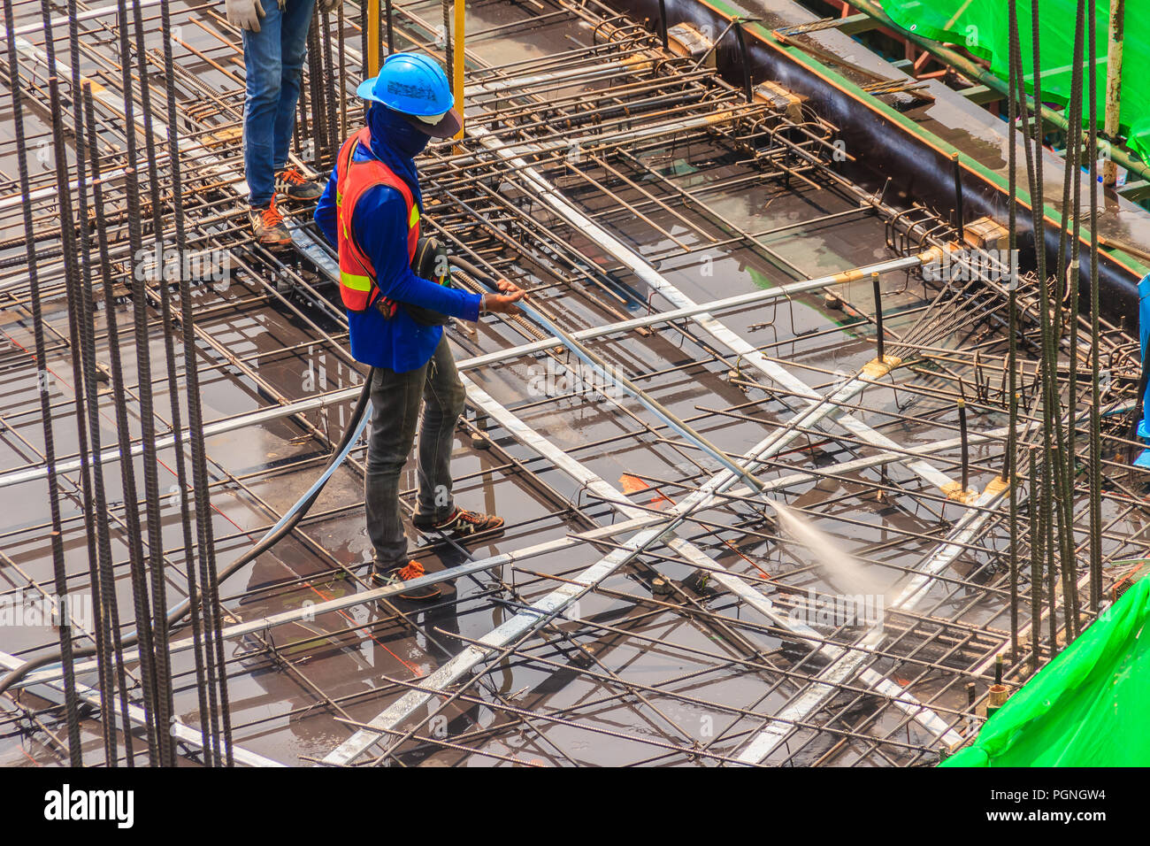 Unidentified worker used the high pressure machine to clean floor slab