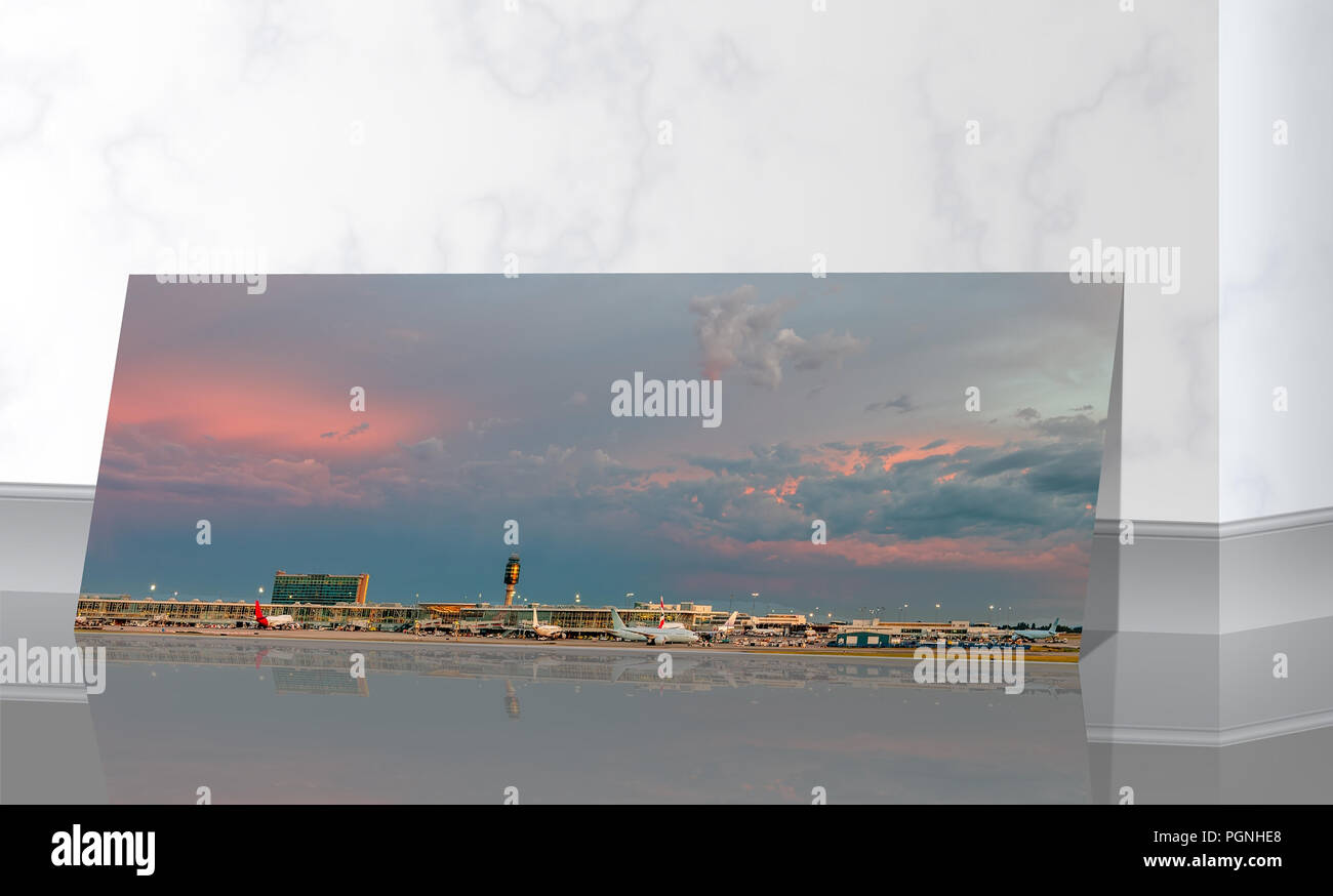 near the marble wall is a panoramic photo of a huge sky with clouds, illuminated by sunlight above the airport building and planes Stock Photo