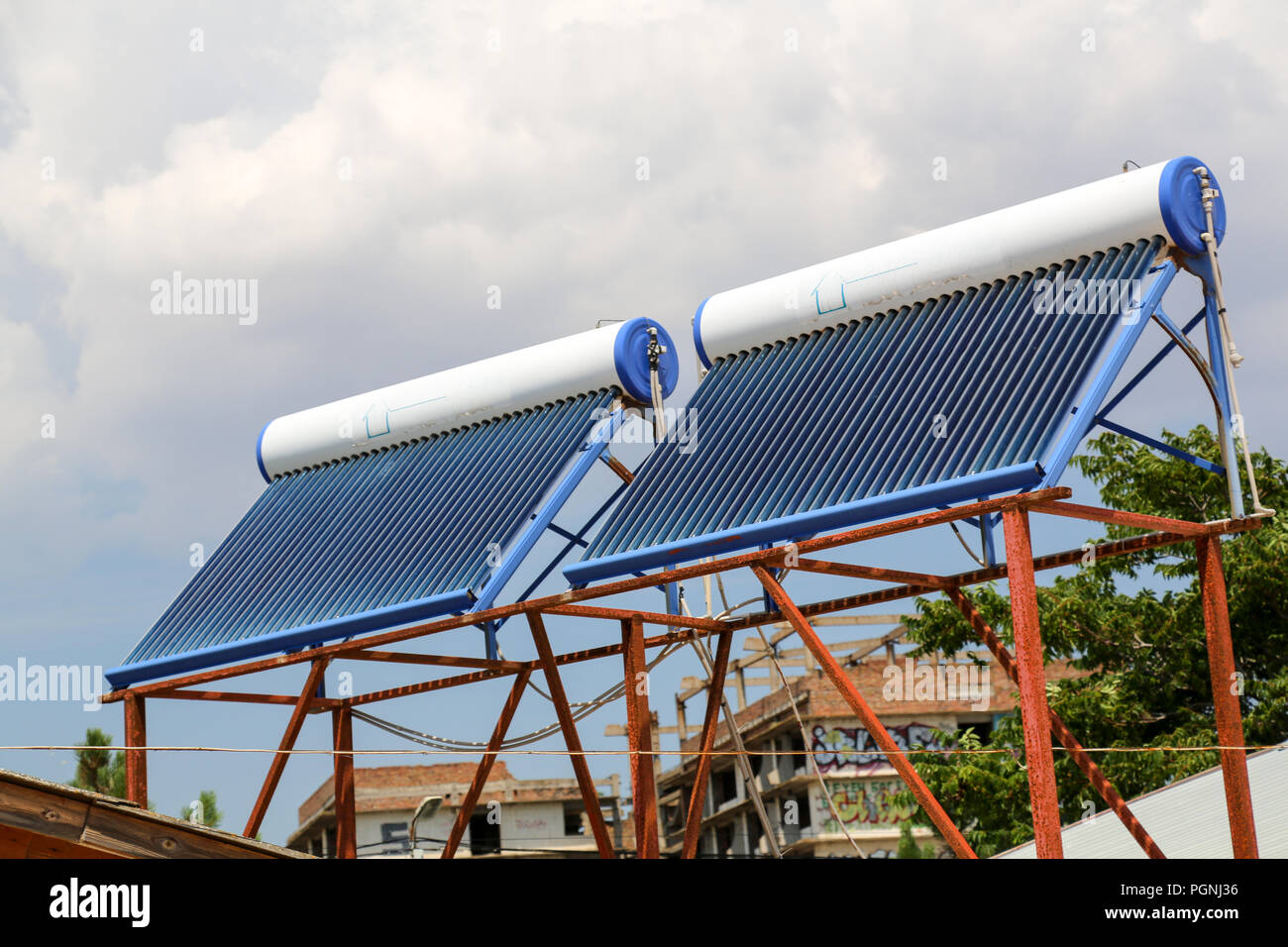 Vacuum solar cells for water heating system on the house roof Stock Photo