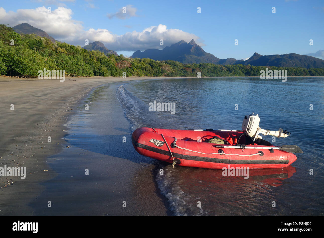 Red inflatable boat on beach, Zoe Bay, Hinchinbrook Island National