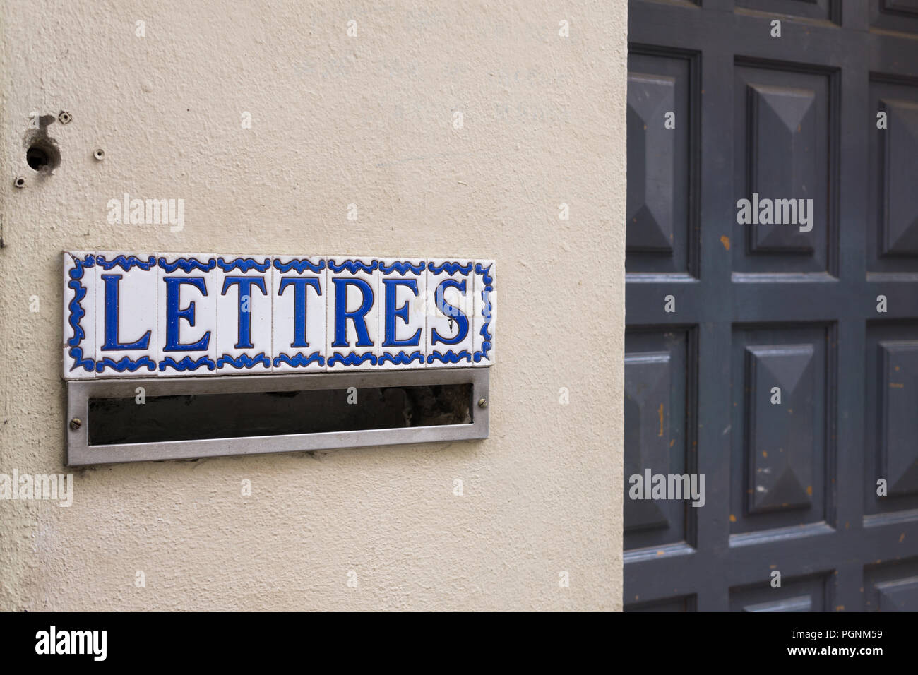 French postbox with a sign ‘Lettres’ in Paris, France. Stock Photo