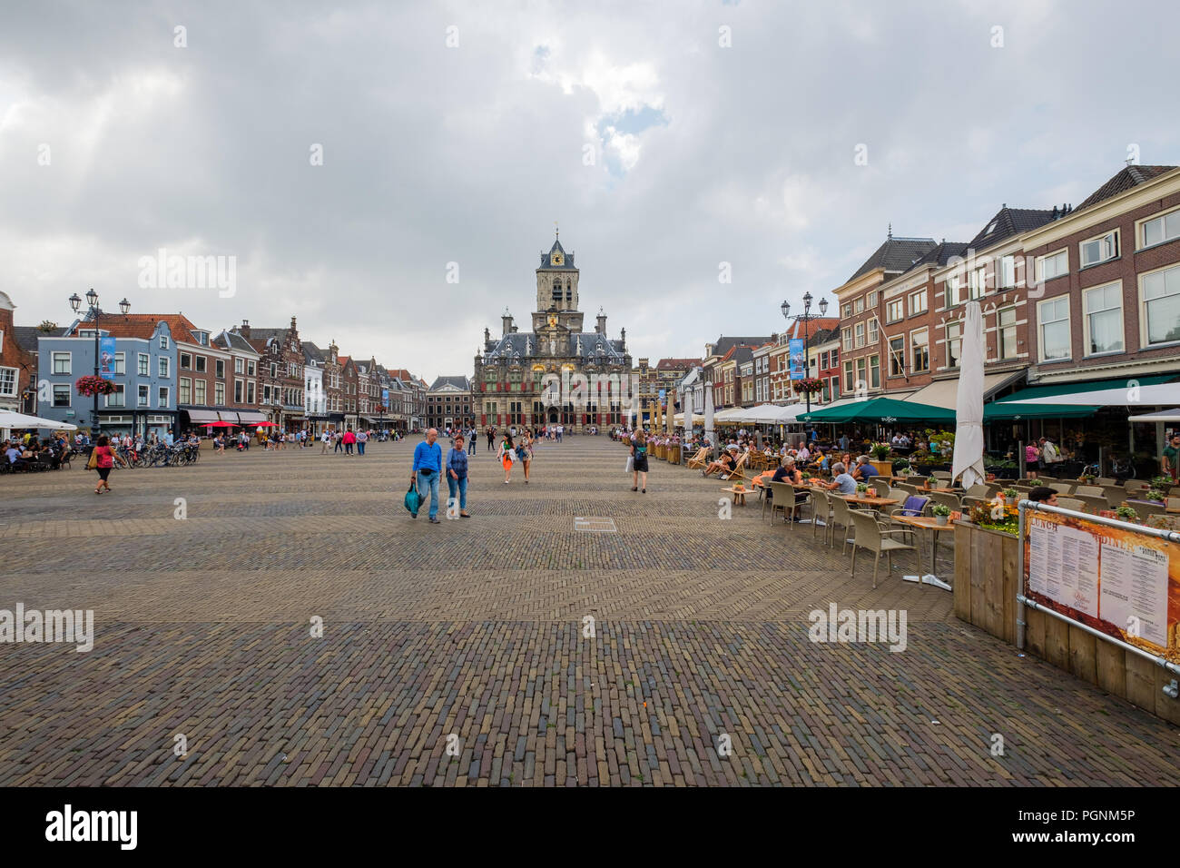 Market square in Delft, Netherlands, with the old town hall in the background and restaurants Stock Photo