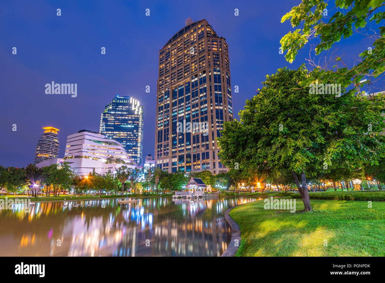 BANGKOK, THAILAND - JULY 16: This is a night view of Benchasiri Park lake and city buildings on July 16, 2018 in Bangkok Stock Photo