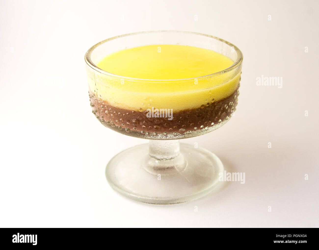 Mousse, pudding, souffle with vanilla and chocolate in glass white, bright background. Stock Photo