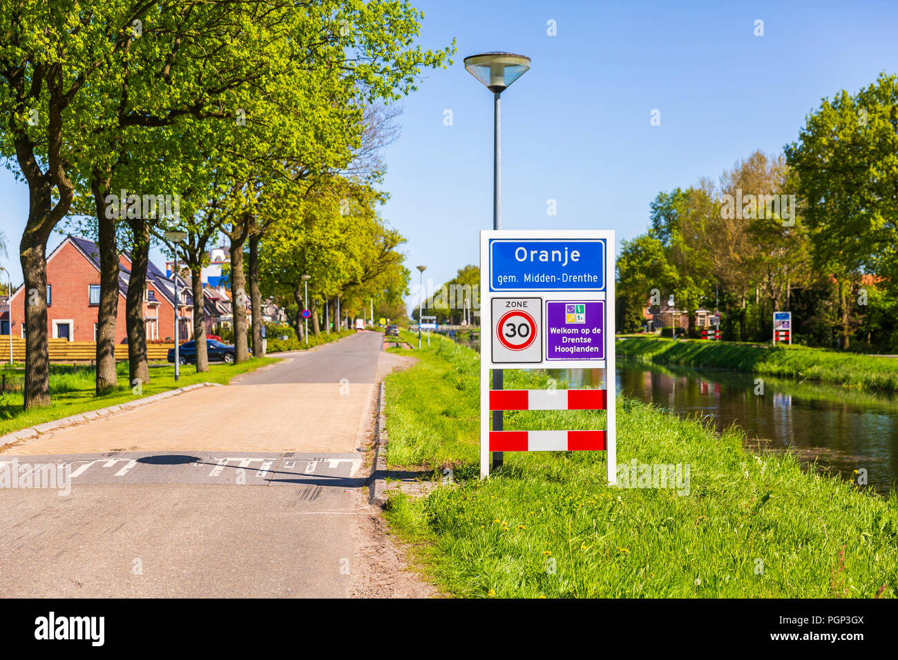 Roadsign to welcome visitors and tourism to the small village Oranje, Drenthe, the Netherlands. Warm sunny day with clear bue sky. Stock Photo