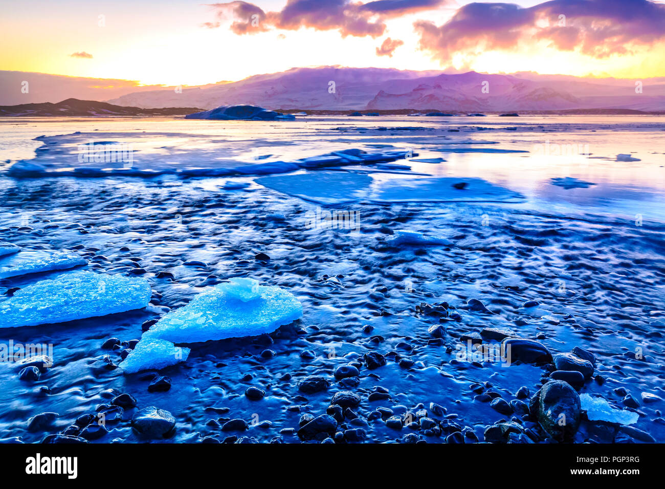 Jokulsarlon glacier lake in Iceland during sunset in Winter season. The lake is growing every year due to global warming. A popular place for tourists Stock Photo