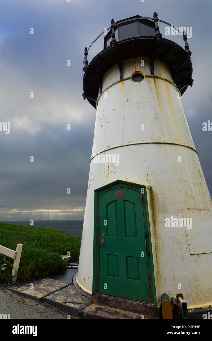 Sun rays reach down through heavy cloud cover beyond Pigeon Point Light Station. Stock Photo